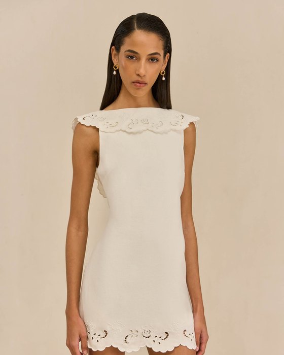 An off-white dress with a structured bodice.